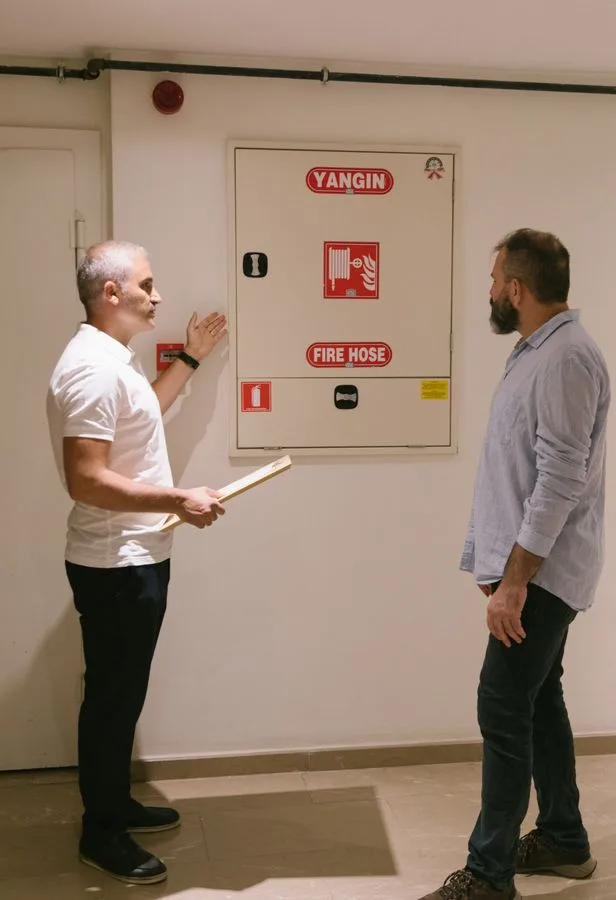 Fire safety inspector checking equipment in commercial building